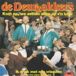 De Deurzakkers - Kom Op, We Zetten Alles Op Z'n Kop! / Ik Drink Met M'n Vrienden (In M'n Eigen Stamcafé) (7", Single)